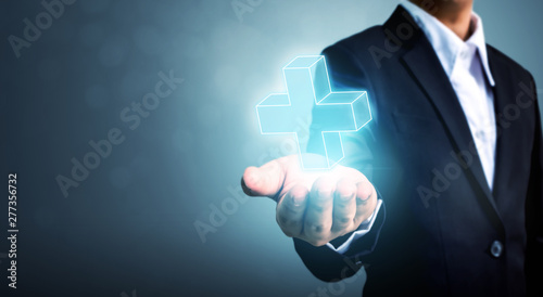 Cuadro en lienzo Businessman hand holding plus sign virtual means to offer positive thing (like b