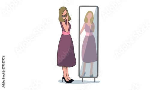 Woman in a dress looking at her reflection in a long mirror