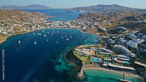 Aerial drone photo of paradise celebrity bay of Ornos famous for pool resorts and sandy turquoise organised clear sea beach, Mykonos island, Cyclades, Greece