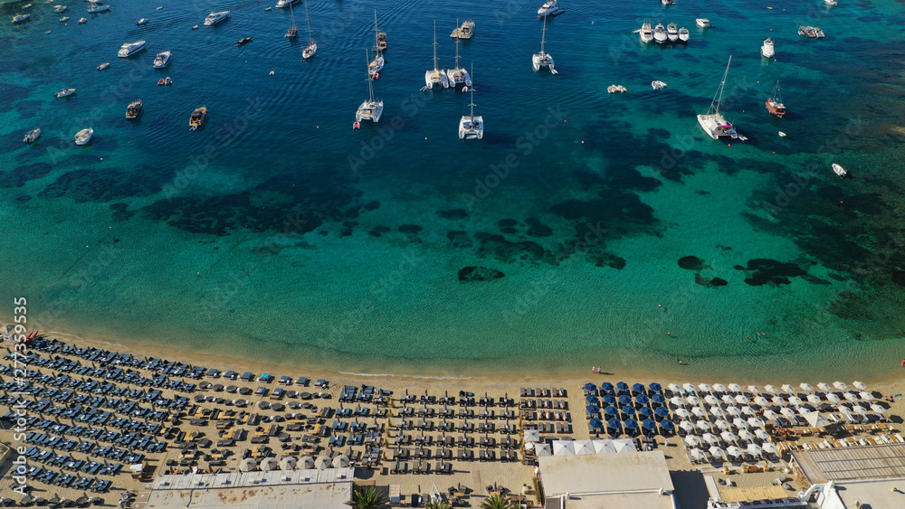 Aerial drone photo of paradise celebrity bay of Ornos famous for pool resorts and sandy turquoise organised clear sea beach, Mykonos island, Cyclades, Greece