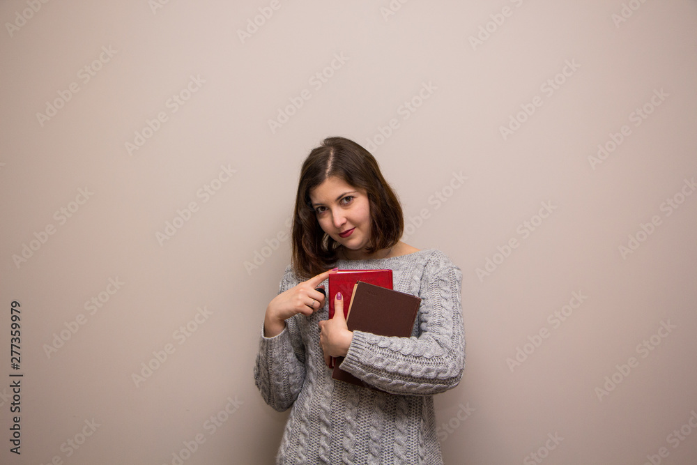 Portrait of young brunette woman with book in her hand Portrait of young brunette woman with book in her hand