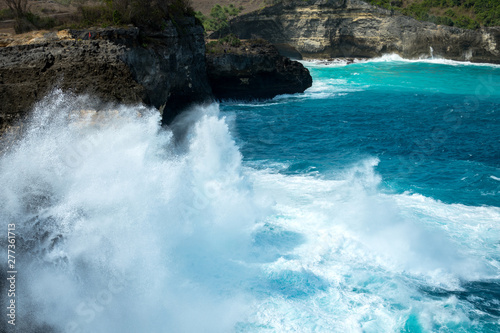 Severe water wave is impact on the stone cliff, cause very high of water blow. Here is the famous natural phenomenon at Angel Billabong, the famous location at Nusa Penida island, Bali - Indonesia. 