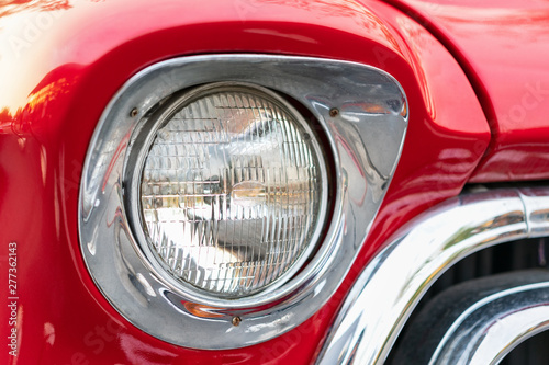 Classic red car headlights. © thepoo