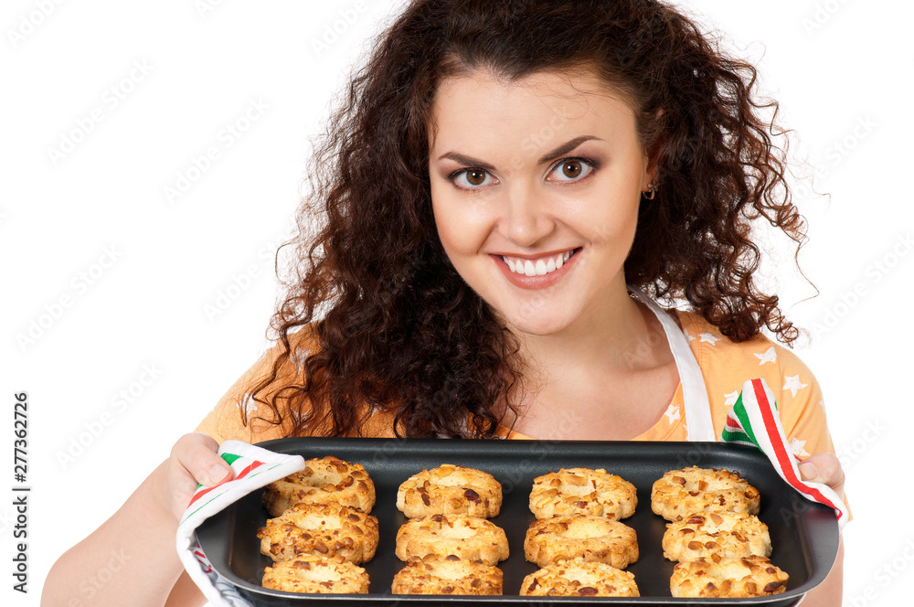 Young beautiful housewife showing tray of cookies fresh from oven, isolated on white background. Studio shot, close-up. Young beautiful housewife showing tray of cookies fresh from oven, isolated on white background. Studio shot, close-up.