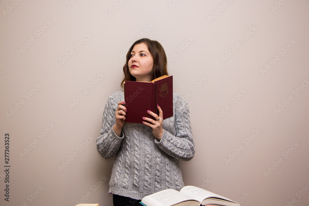 Portrait of young brunette woman with book in her hand Portrait of young brunette woman with book in her hand