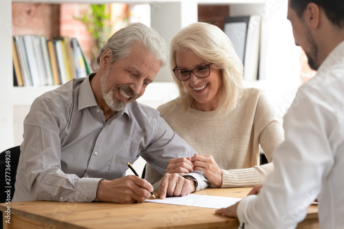 Fényképezés Happy older couple clients sign insurance contract meeting agent