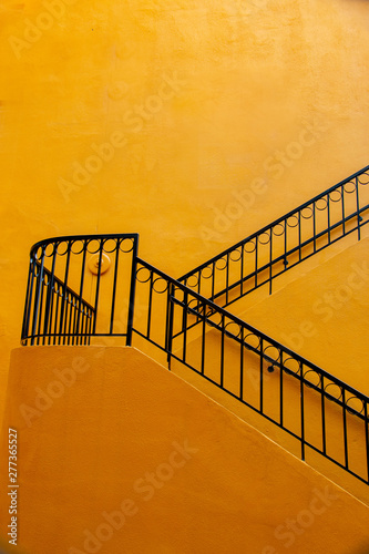abstract orange wall black railing