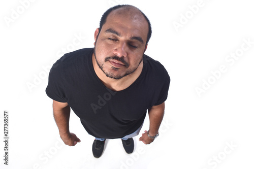 portrait of a latin american man eyes clossed on white background