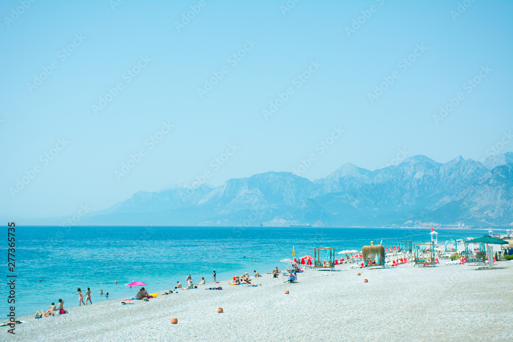 Konyaaalti beach in Antalya, Turkey, blue mediterranean sea, sunny weather. Travel and vacation at the resort