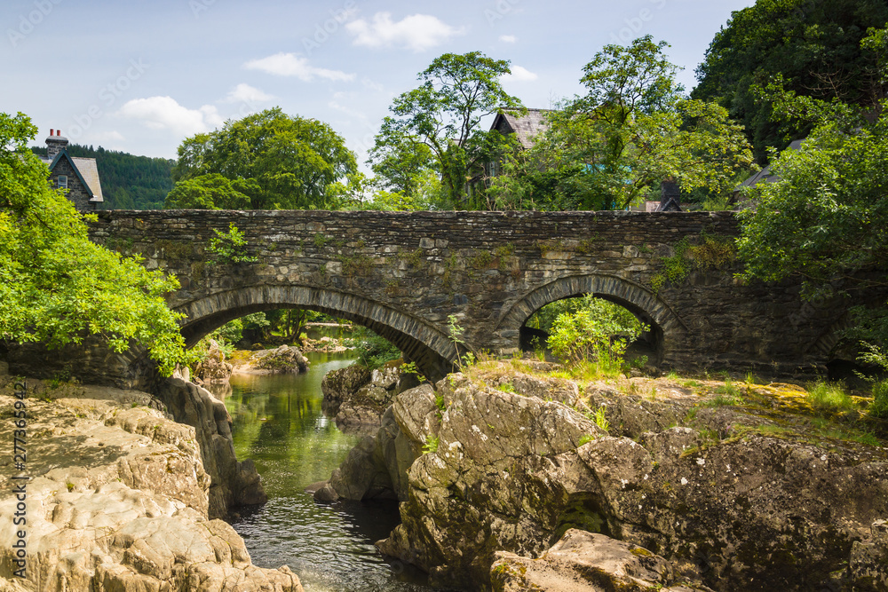 The medieval Pont-y-Pair Bridge over the River Llugwy in the village of Betws-y-Coed North Wales