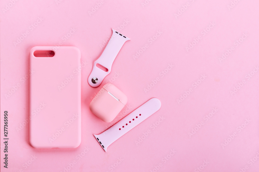 Up to date technology.Top view of diverse personal accessory laying on the pink background