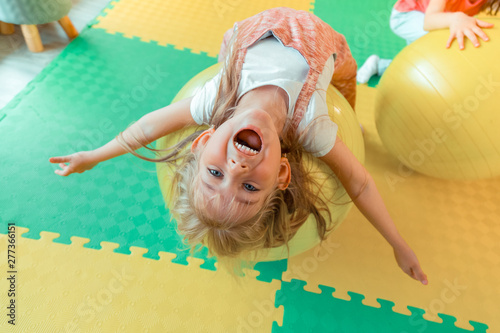 Fototapeta Naklejka Na Ścianę i Meble -  Top view of a happy excited cute girl