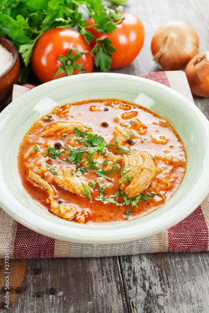 Traditional georgian soup kharcho in a plate on the table Traditional georgian soup kharcho in a plate on the table