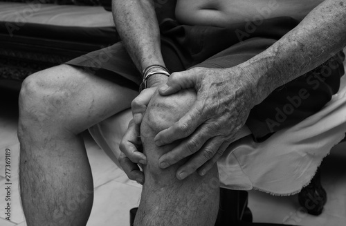 Elderly man suffering from pain in knee, Pain In The Elderly, Health care, total knee replacement. black and white tone