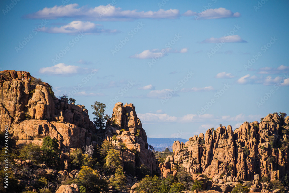 The rugged Granite Dells geologic feature in Prescott Arizona. This image provides copy space in the sky with some clouds.