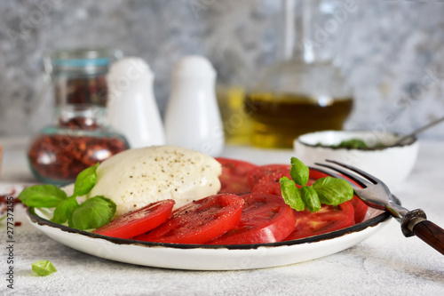 Caprese is a classic Italian snack with mozzarella, tomatoes and olive oil.