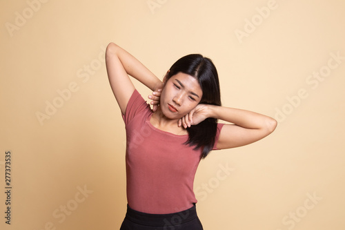 Sleepy young Asian woman yawn.