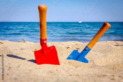 Small spade and shovel for digging sand on the beach.