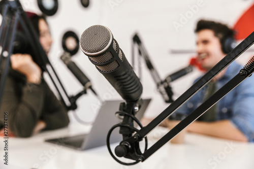 Two radio hosts moderating a live show photo