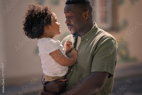 portrait of father holding daughter on the hands and talking