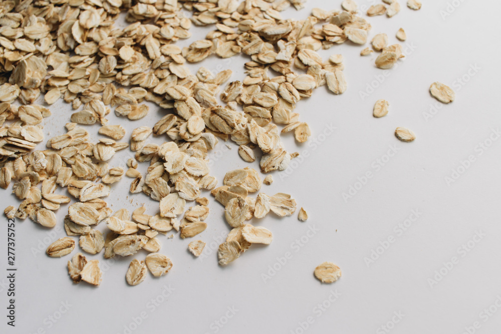 Jar with raw oat-flakes on white background Jar with raw oat-flakes on white background