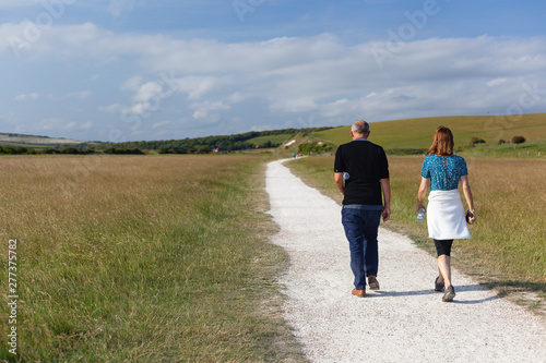 A couple strolling through the British countryside