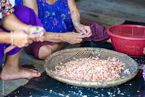 Fisherman female are preparing the dried shrimp for sales.