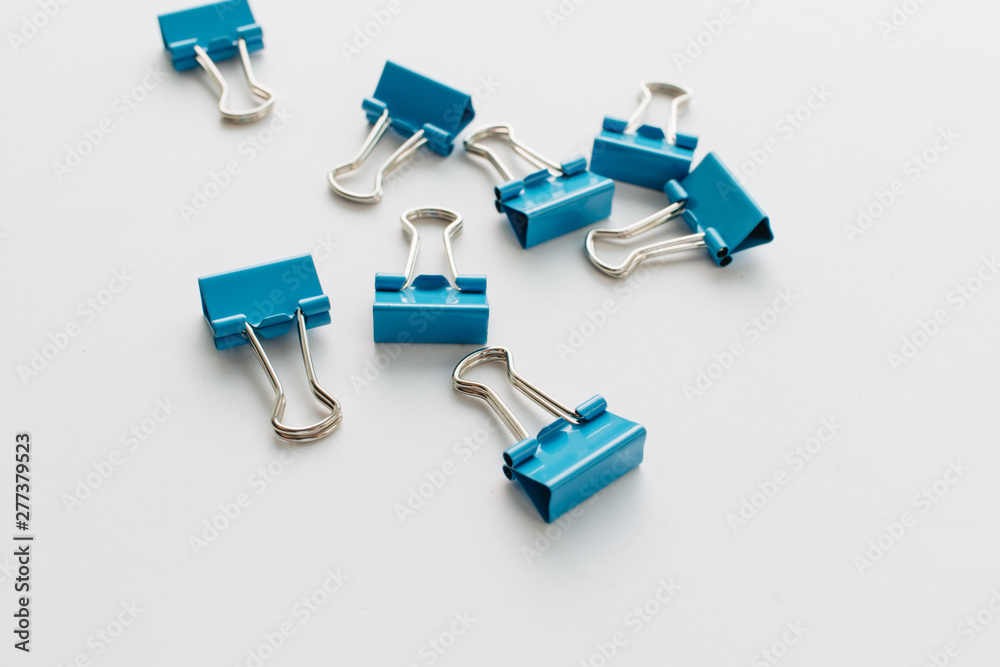 Pile of blue paper clips on blue background Pile of blue paper clips on blue background