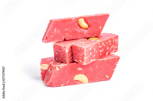 Pomegranate halva isolated on white. Oriental sweets, cakes. Uzbek dessert. Pink halvah with nuts cashews, almonds. National food