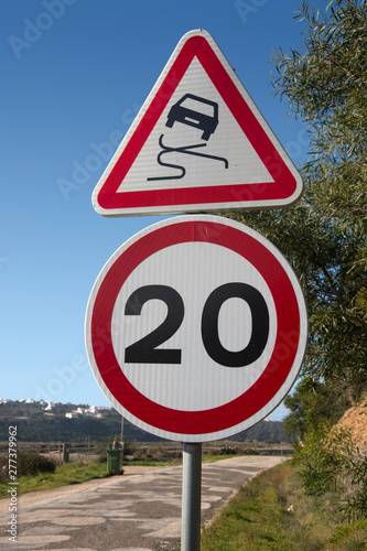 Road sign, car skidding 20MPH warning
