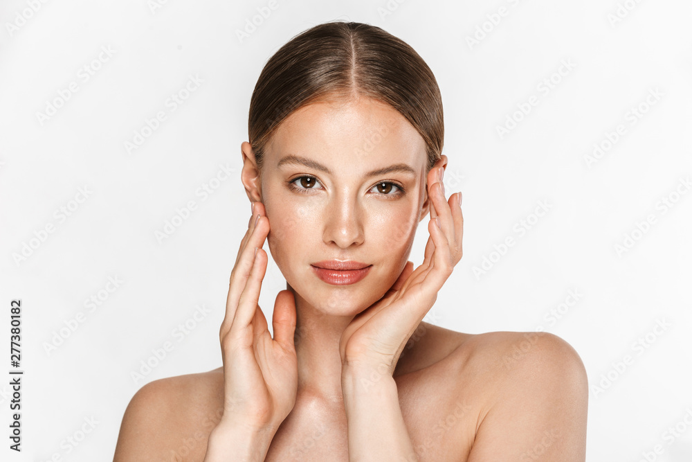 Image of charming half-naked woman looking at camera and touching her face Image of charming half-naked woman looking at camera and touching her face