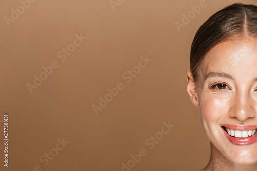 Half side image of pretty half-naked woman smiling and looking at camera near copyspace