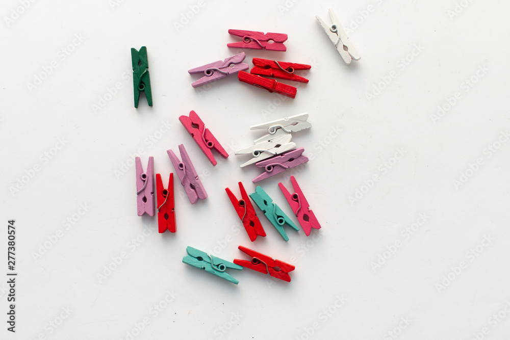 Pile of scattered clothes pegs isolated on white background Pile of scattered clothes pegs isolated on white background