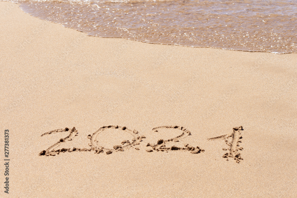 Happy new year 2021 text on the beach. Planning vacation. Happy new year 2021 text on the beach. Planning vacation.