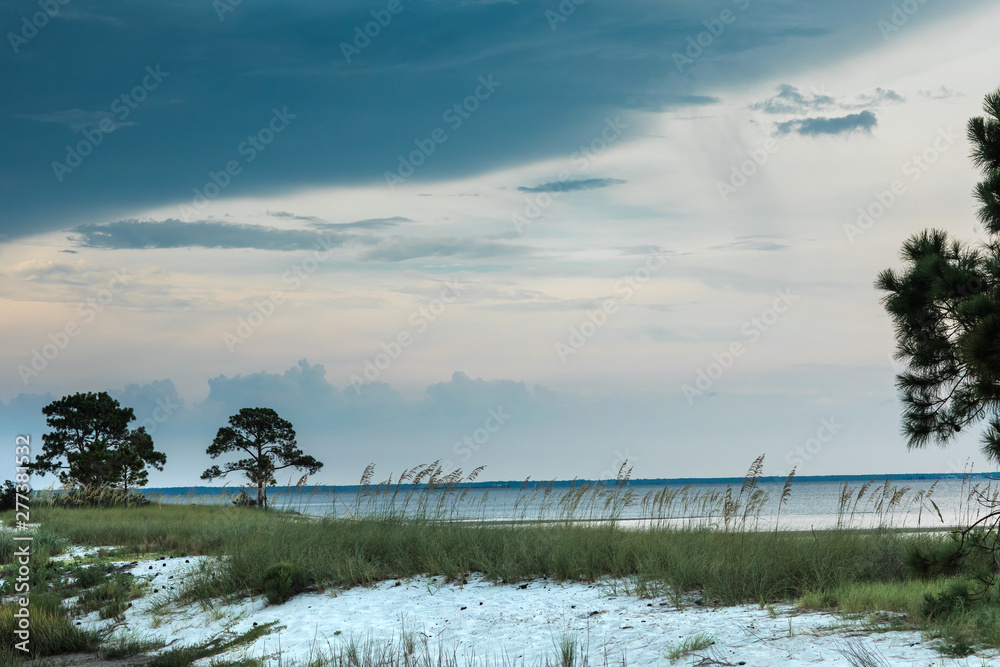 Florida State park Beach Coastline Landscape at Sunset. Sand, water and sky with clouds.