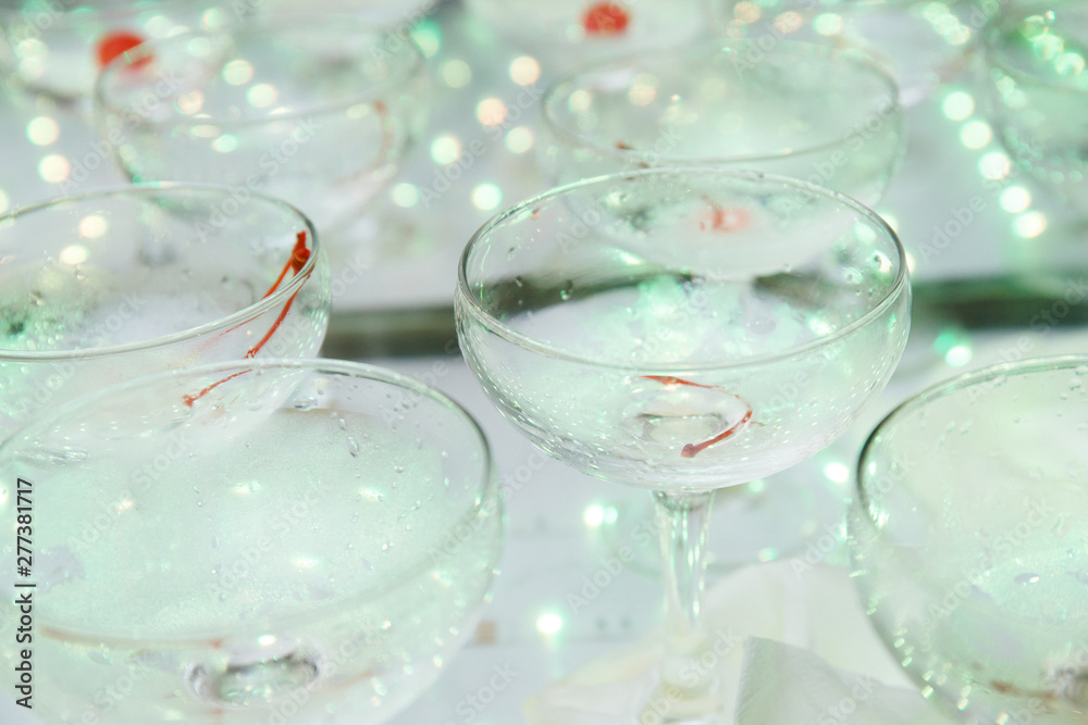 empty champagne glasses on the table with LED illumination. bar table after the party with transparent glass glasses and the remnants of champagne. concept of a fun party, celebration, wedding, prom empty champagne glasses on the table with LED illumination. bar table after the party with transparent glass glasses and the remnants of champagne. concept of a fun party, celebration, wedding, prom