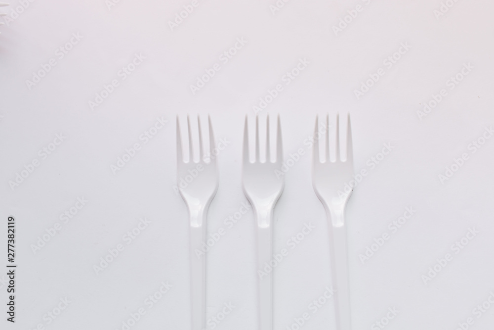 White plastic forks flat lay on white background White plastic forks flat lay on white background