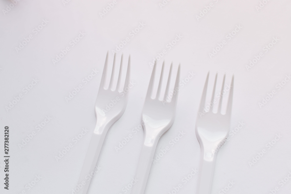 White plastic forks flat lay on white background White plastic forks flat lay on white background