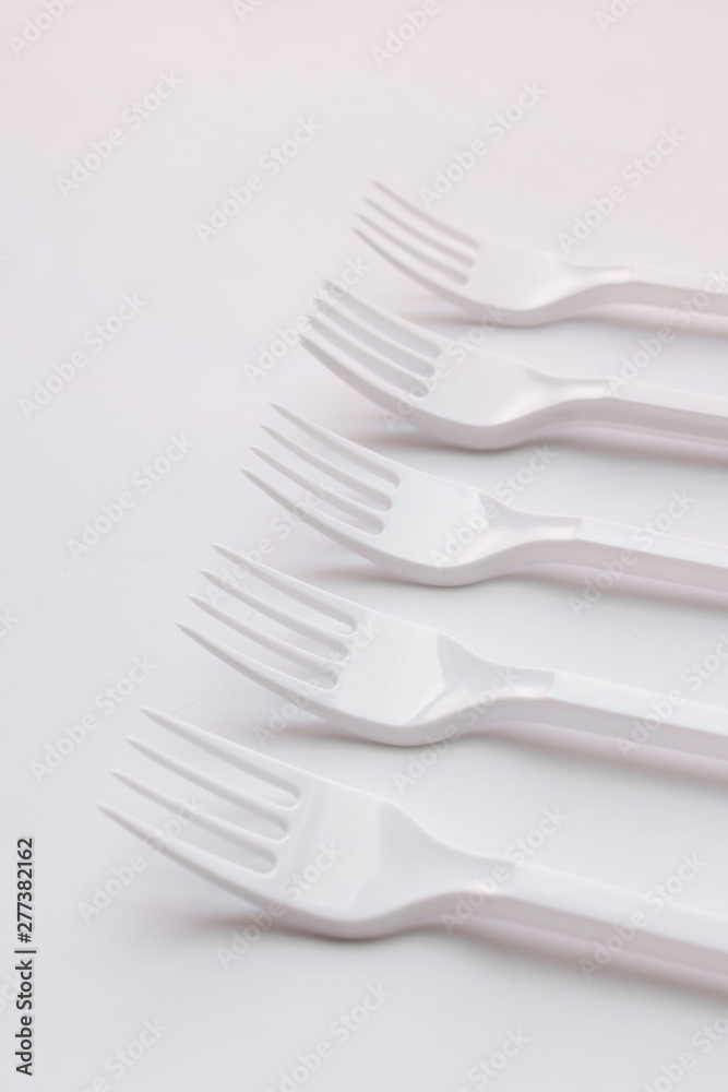 White plastic forks flat lay on white background White plastic forks flat lay on white background