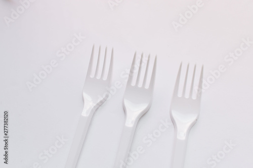 White plastic forks flat lay on white background