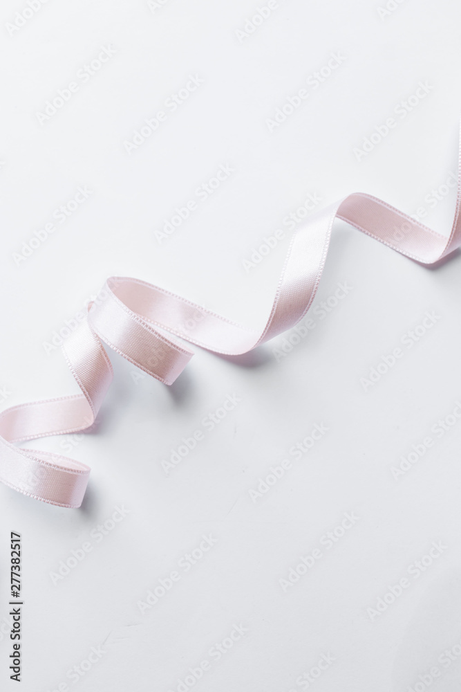 Light pink ribbon decoration on white background Light pink ribbon decoration on white background
