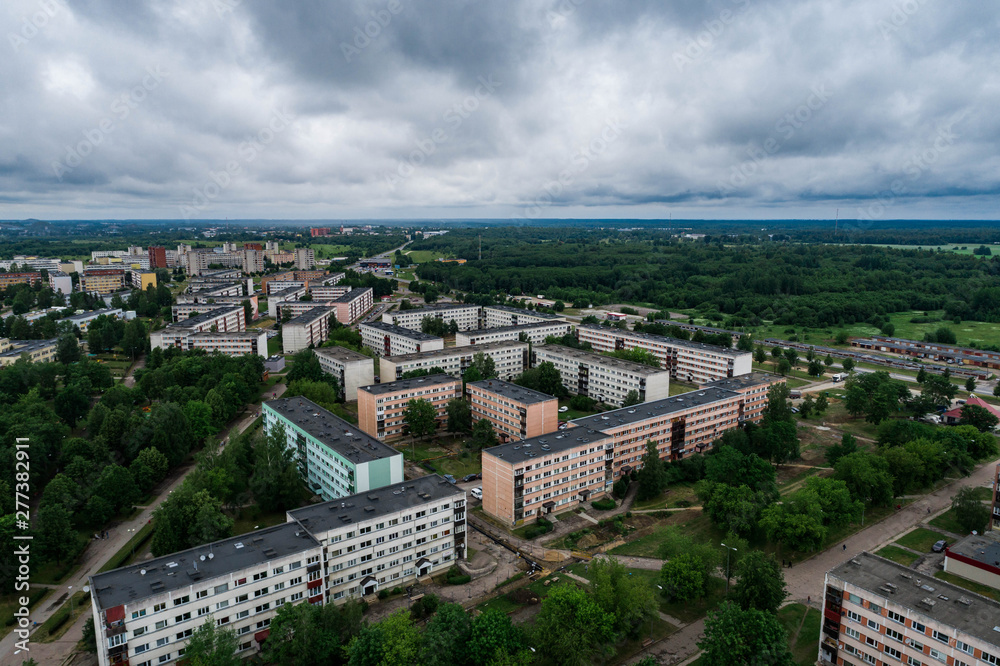 Aerial view of the city under dark storm cloudy sky. Just before the storm over the city. 