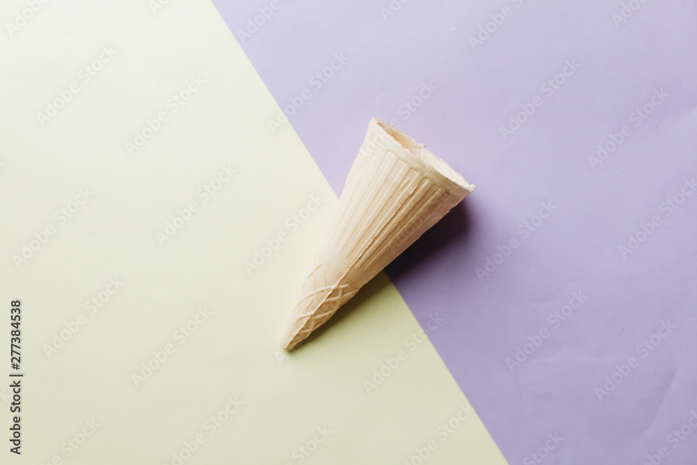 Fototapeta premium Crispy waffle cone on light background