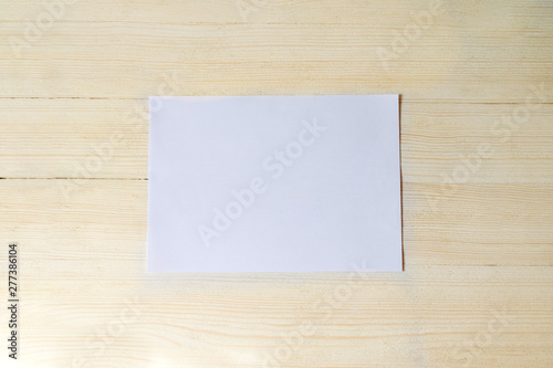 the white piece in the center on a beige wood background