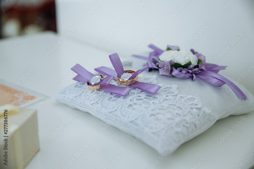 wedding rings on a white background in a wedding decoration wedding rings on a white background in a wedding decoration