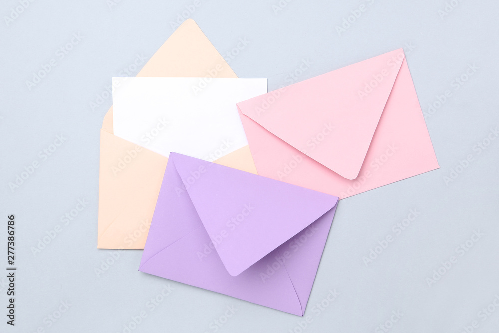 Colorful paper envelopes on grey background Colorful paper envelopes on grey background