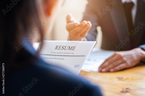 Interviewer reading a resume, Person submits job application, Person describe yourself to interviewer, Close up view of job interview in office, recruiter considering application, hr manager making hi