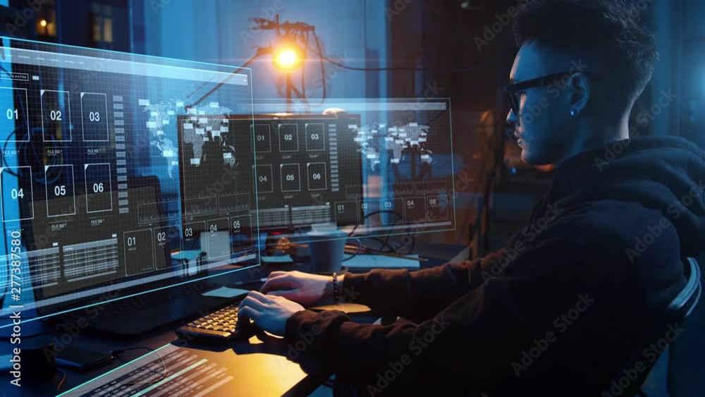 cybercrime, hacking and technology concept - asian male hacker in dark room writing code or using computer virus program for cyber attack