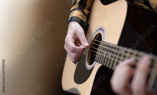 Acoustic Guitar Playing. Young men Playing Acoustic Guitar