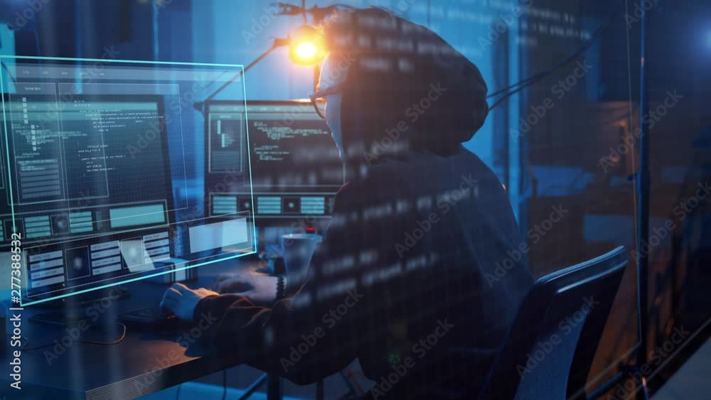cybercrime, hacking and technology concept - asian male hacker in dark room writing code or using computer virus program for cyber attack